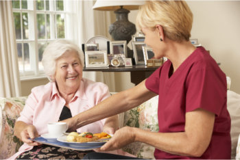 caregiver preparing food for the patient