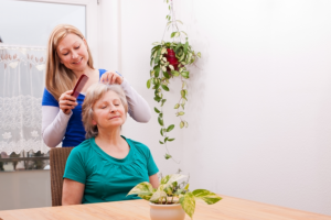 caregiver combing the patients hair